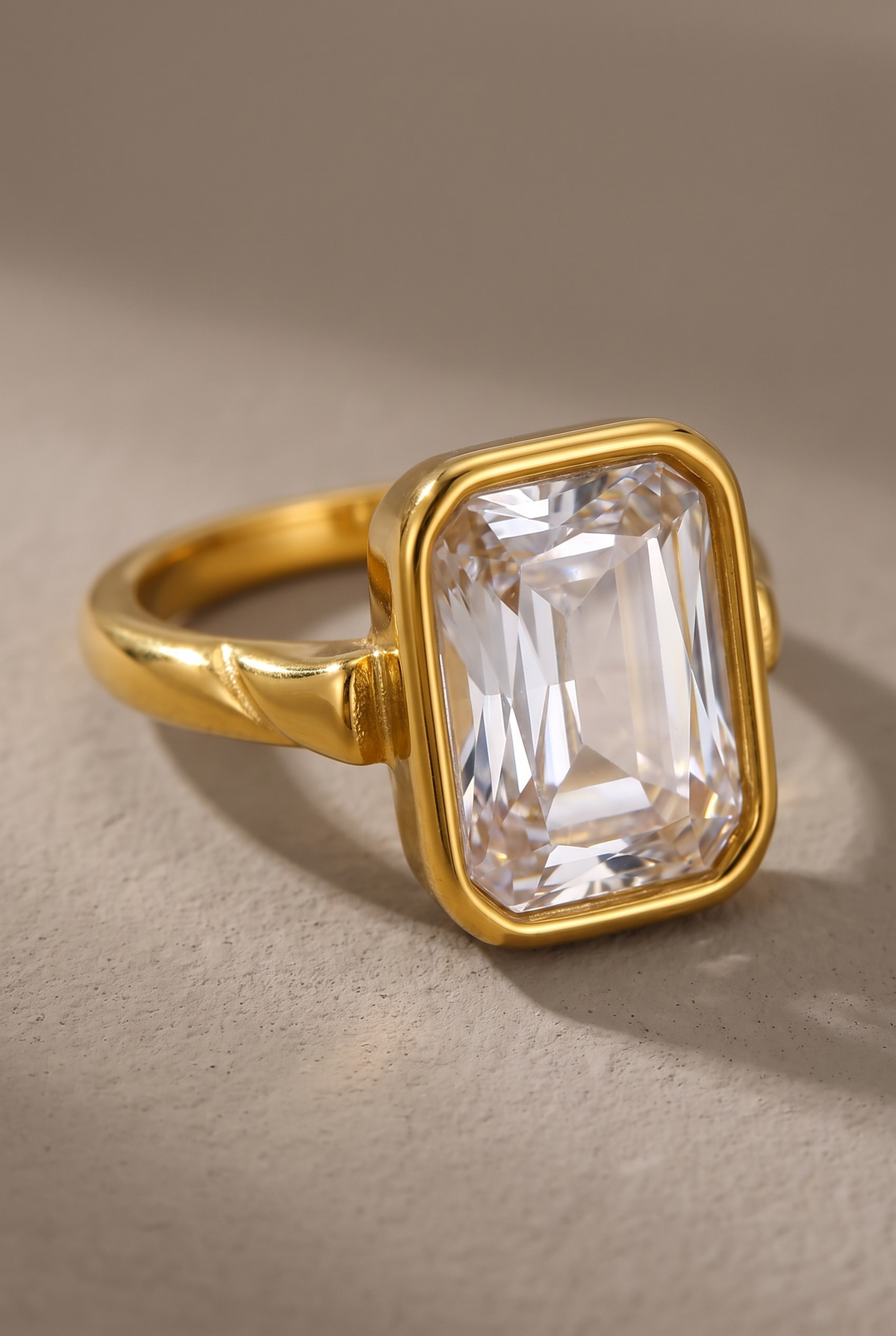 Close-up of the bezel-set emerald-cut clear stone