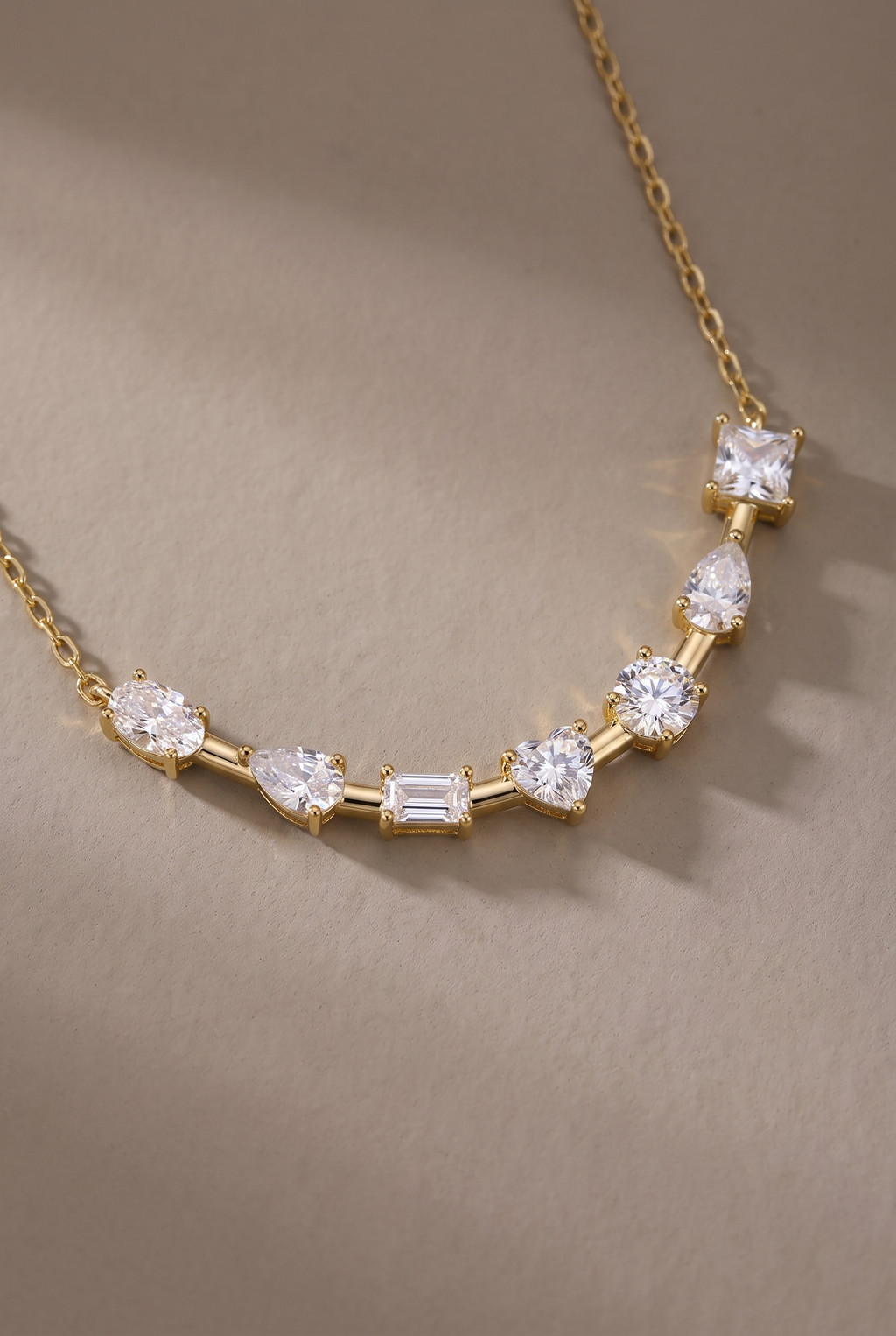 Close-up of the seven prong-set stones on the curved bar
